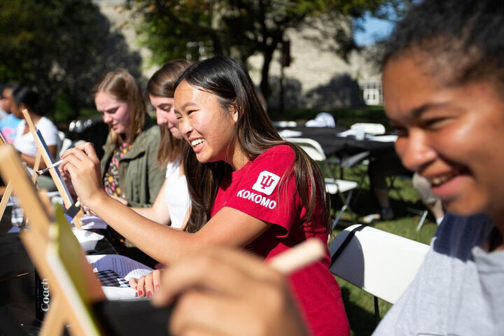 Smiling students in a painting class on the grounds of the IU Kokomo campus.